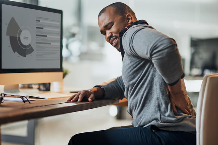 Man at desk with back pain.