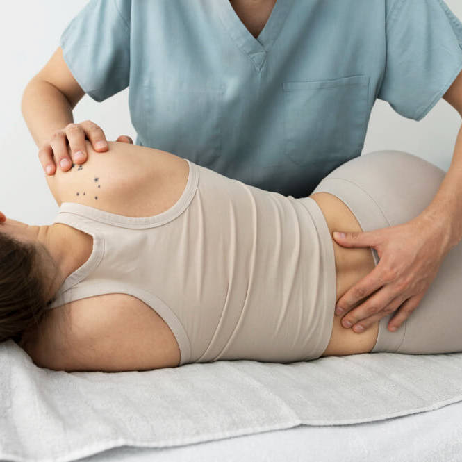 Home 6 A therapist providing a back massage to a client on a treatment table.